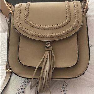 Cute beige small cross body purse.